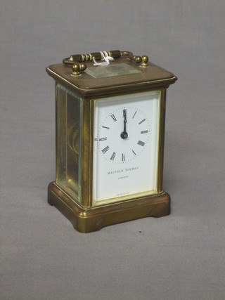 A 19th Century Swiss carriage clock with porcelain dial and Roman numerals contained in a gilt metal case marked Matthew Norman London