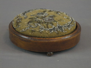 A Victorian circular mahogany footstool with bead work top 11"