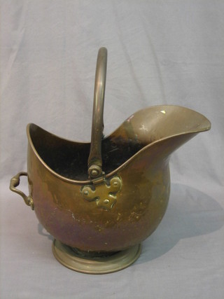 A copper helmet shaped coal scuttle