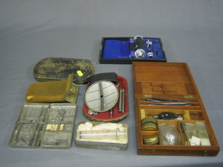A glass syringe boxed, a Diagnostic set, a stitching set, 1 other medical instrument and a box of slides