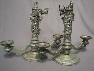 A pair of impressive Eastern white metal twin light candelabrum decorated dragons and Dogs of Fo 16"