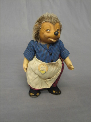A Steiff lady hedgehog, wearing an apron, complete with paper label 10"