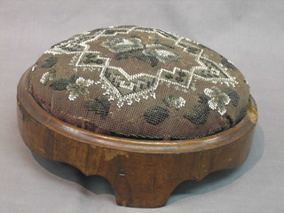 A circular Victorian walnut footstool with bead work top 12"