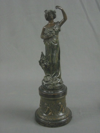 A spelter figure of a standing classical lady, raised on a wooden socle base 16"