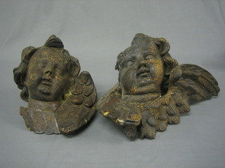 A handsome pair of 18th/19th Century carved limewood heads in the form of cherubs 10" (1 slightly damaged)