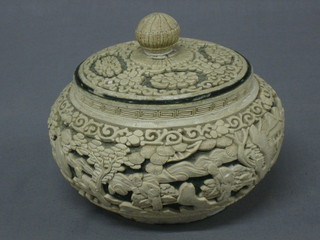 A Chinese carved Whiteware jar and cover decorated buildings etc 7"