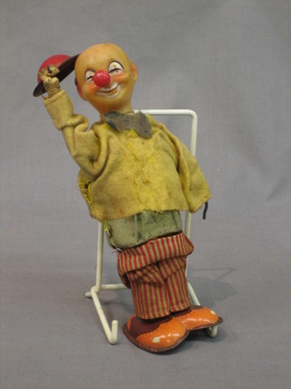 A clockwork tin plate model of a clown 9"