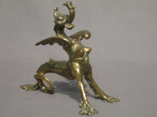 A 19th Century brass ornament fire dog in the form of a griffin 6"