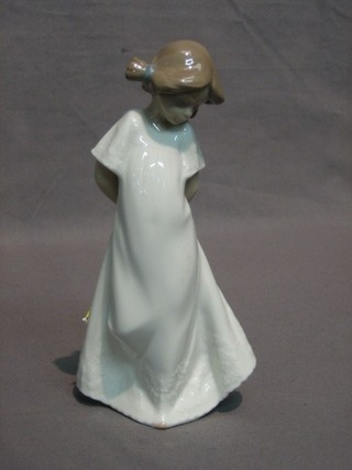 A Nao figure of a standing girl, base marked 1989 8"
