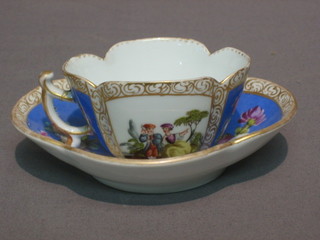 A Dresden style cabinet cup and saucer with blue panel decoration and gilt banding