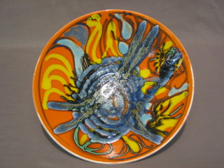 A circular Poole Pottery Atomic orange bowl, the base marked 57, 11"