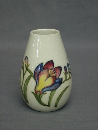 A Moorcroft  Crocus pattern and crackle glazed vase, the base impressed Moorcroft England, firing crack to base, 5"