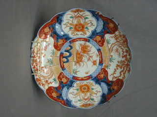 A 19th Century circular Japanese Imari porcelain plate with lobed and panelled body, 12"