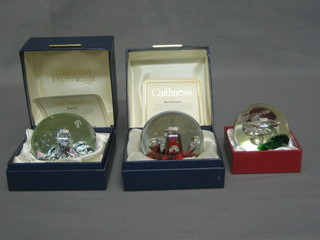 A Caithness Myraid paperweight, a Caithness Moonflower paperweight and a Royal Crest Pirouette paperweight, all boxed