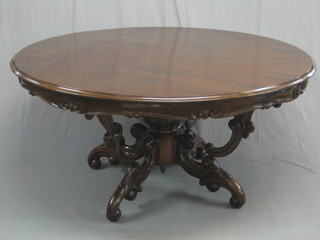A 20th Century Victorian style Eastern carved hardwood circular centre table, raised on a carved column 59"