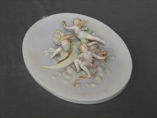 A 19th Century oval porcelain wall plaque depicting cherubs 14" (cherub wing f and r)