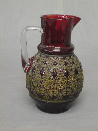 A 19th Century Continental red glass jug with clear glass handle and applied metal decoration 8"