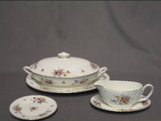 A 34 piece Minton Marlow pattern dinner service comprising 2 oval tureens and covers 13", an oval meat plate 13 1/2", a Monteith style twin handled oval centre piece 3", a 3 piece condiment comprising salt pepper and mustard, slat boat and stand, 7 side plates 8", 7 dinner plates 11", 7 pudding bowls 6 1/2", 6 tea plates 6 1/2", 6 coffee cups and 6 saucers