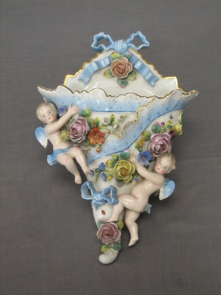 A Victorian porcelain wall pocket decorated cherubs 12"
