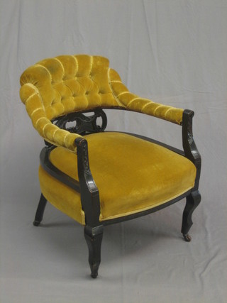 An Edwardian ebonised tub back chair upholstered in yellow material