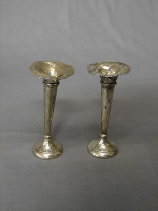 A pair of silver trumpet shaped specimen vases, Chester 1911, 6 1 2/2" (battered and marks rubbed)