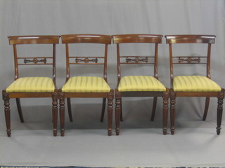 A set of 4 19th Century rosewood bar back dining chairs with pierced mid rails and upholstered drop in seats, raised on turned and reeded supports
