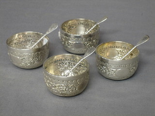 A set of 4 Victorian circular embossed silver salts, London 1883 together with matching spoons, 6 ozs