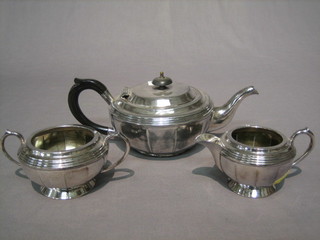 A circular silver plated 3 piece tea service with teapot, twin handled sugar bowl and cream jug