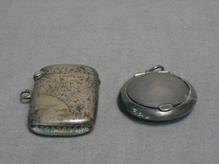 An Edwardian engraved silver vesta case, Birmingham 1900 and a miniature silver compact Birmingham 1923