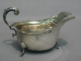 A Georgian style silver sauce boat with C scroll handle and wavy border, Birmingham 1922, 2 ozs