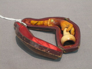 A Victorian cheroot holder in the form of a clasped hand (finger and mouth piece f)