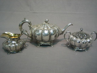 A 3 piece melon shaped Britannia metal tea service with teapot, twin handled sugar bowl and cream jug