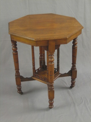 An Edwardian octagonal walnut occasional table, raised on turned supports 23"