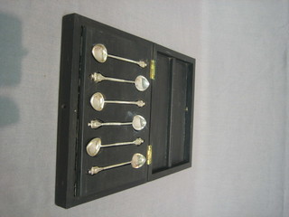 A set of 6 Eastern "silver" coffee spoons, the handles in the form of standing Deities, contained in a hardwood case