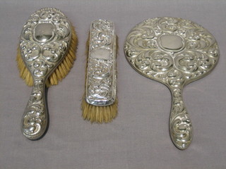 A silver plated handmirror, do. hairbrush and a silver clothes brush