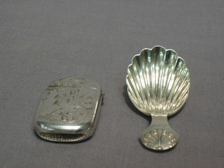 A silver shell shaped caddy spoon, Birmingham 1916 and a silver plated vesta case