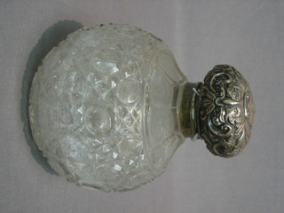 An Edwardian globular shaped cut glass dressing table bottle with embossed silver lid complete with glass stopper, Chester 1902, 5"