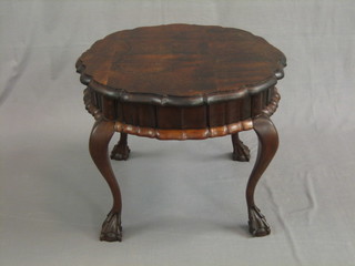 A circular walnut occasional table with pie crust edge, raised on cabriole supports 24"