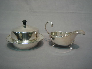 A circular silver plated muffin dish and cover and a Georgian style silver plated sauce boat