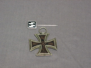 A Nazi Iron Cross Second Class and a Nazi enamelled pin with 2 lightning strikes