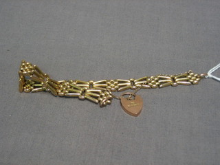 A 9ct hollow gold gate bracelet with heart shaped padlock clasp