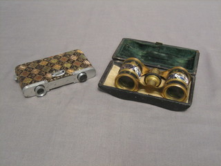 A pair of French gilt and enamel opera glasses and a modern pair of folding opera glasses