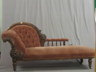 A Victorian mahogany show frame chaise longue with carved bobbin turned back and upholstered in pink material, raised on turned supports 80"