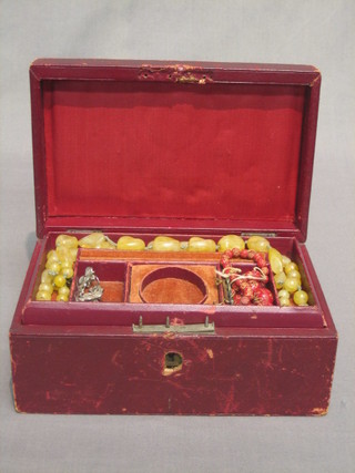 A Victorian red leather jewellery box containing a pocket watch and a collection of costume jewellery