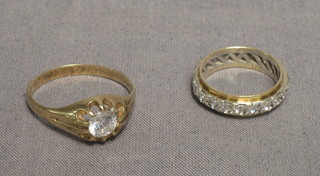 A gold gypsy ring set a stone and an eternity ring (2)