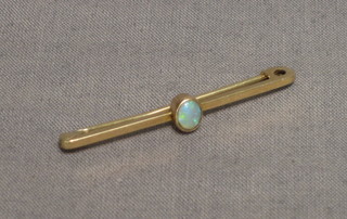 A 9ct gold bar brooch set an oval cut opal