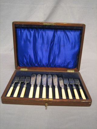 A set of 6 silver plated fish knives and forks contained in a walnut canteen box