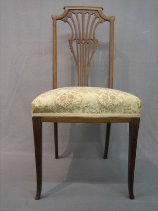 An Edwardian inlaid mahogany bedroom chair with pierced vase shaped splat back and upholstered seat, raised on square tapering supports