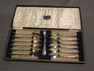 A set of 12 silver plated teaspoons complete with tongs