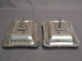 A pair of rectangular silver plated entree dishes and covers